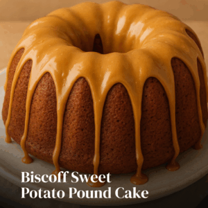Moist Biscoff sweet potato pound cake on a plate, drizzled with glaze and topped with crushed Biscoff cookies.